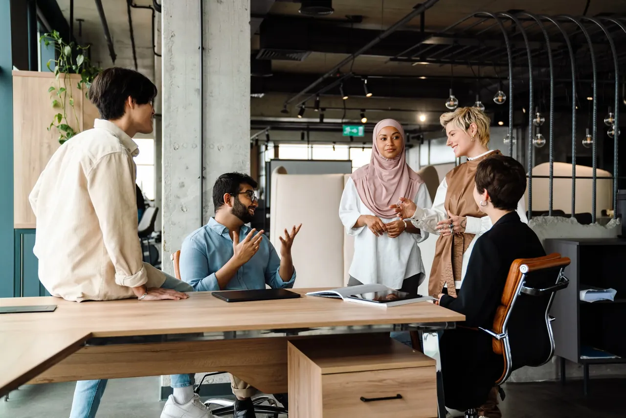 Muslim and Arab American community members talking around a conference table